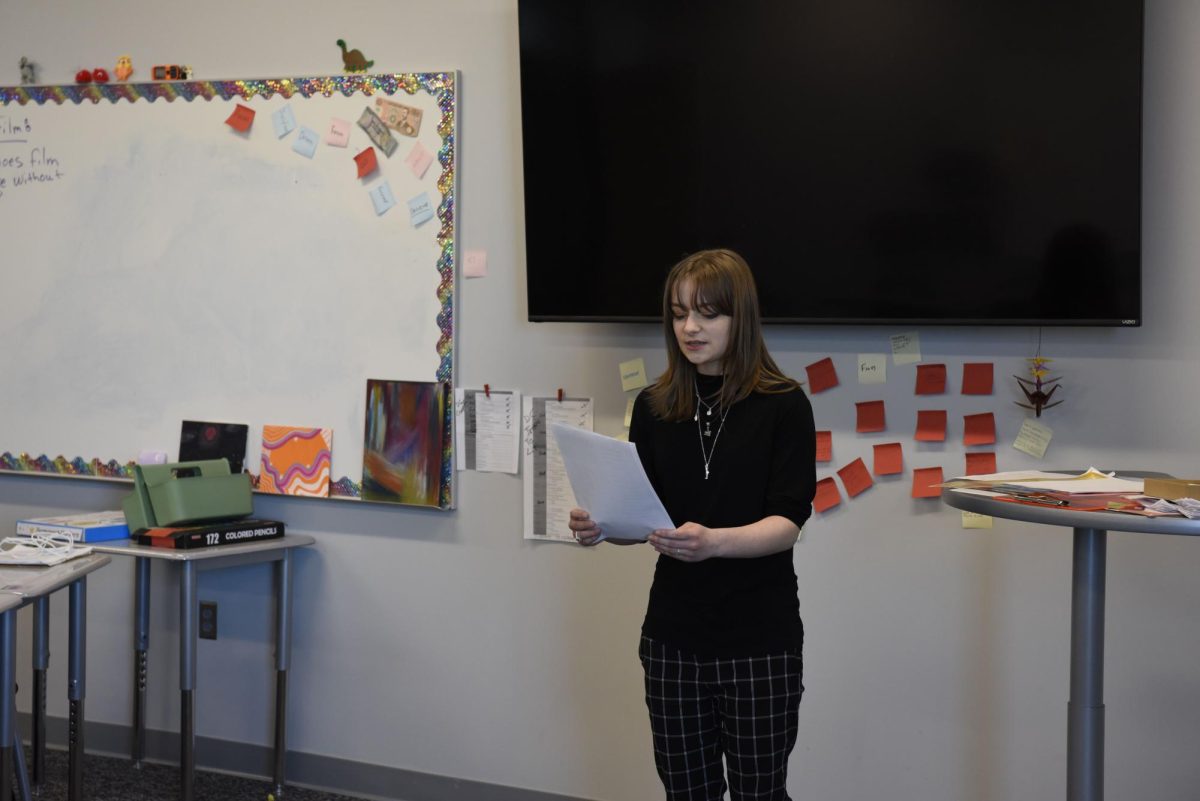 Practicing her poem in front of the club on Feb. 26, senior Maya Thorne expresses her feelings about violence in American schools. Her piece criticized leaders and advocated for change.