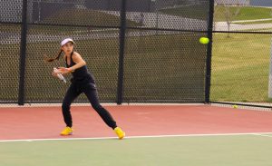 In a match against Pius X, freshman Zoe Katsavelis has her eye on the ball.
