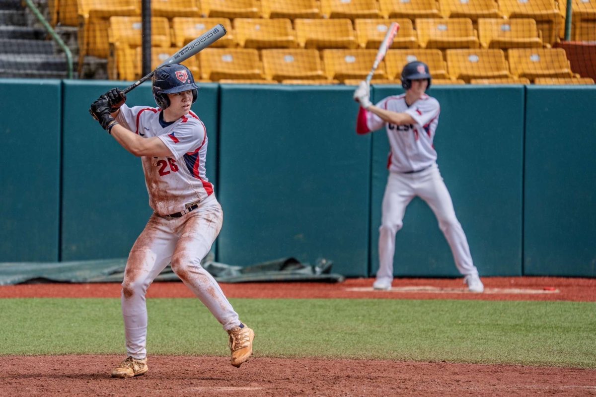 Loading into his back hip and preparing to hit the baseball, Jakub "Kuba" Brown awaits in the batter's box in a game against Team Colombia. Brown played for the Czech National Team at this year's DRD International Academies Baseball Tournament in Puerto Rico. 