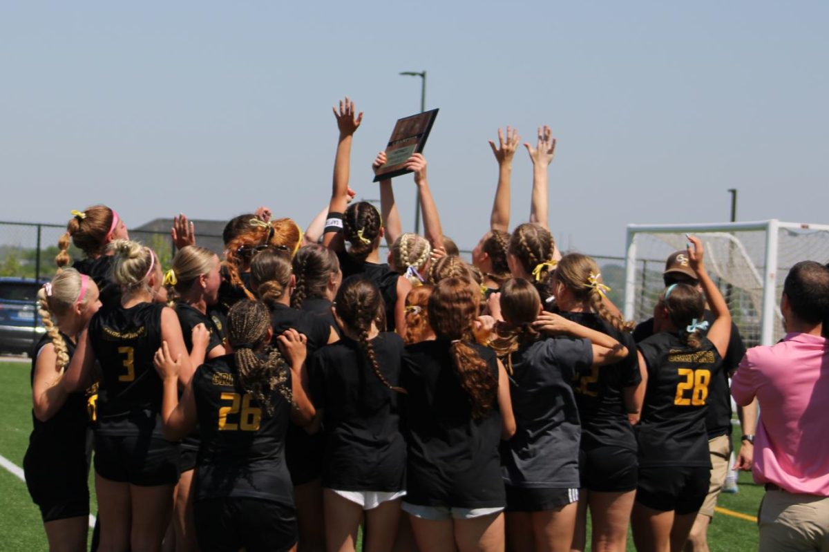 After receiving their plaque from activities director Ryan Garder, the girls' soccer team celebrates.