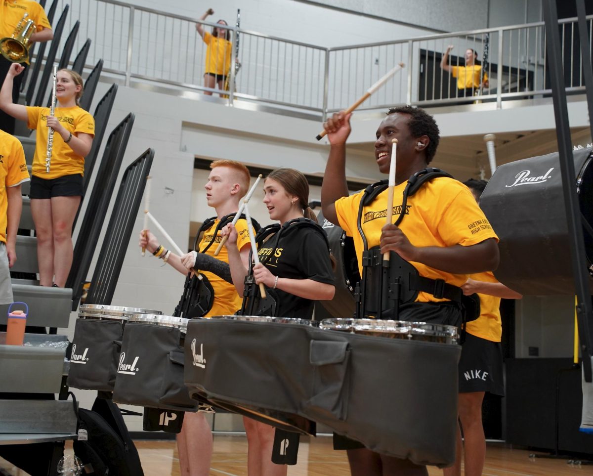 During the Pep Rally finale, freshman Braden Daniels, sophomore Sabrina Nix and junior Timothy White perform the Griffin Fight Song.