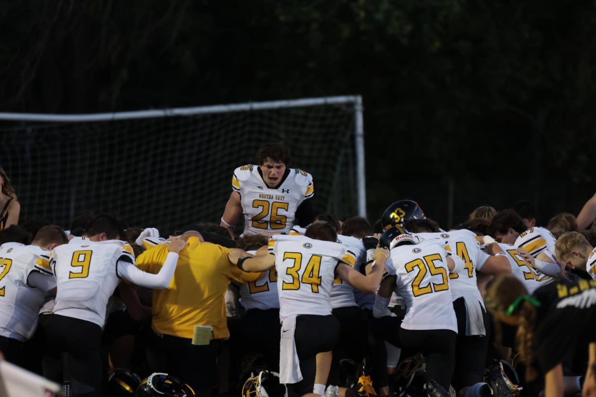 Huddled together in the south endzone of the Ralston football field,  running back, senior Connor Sams gives a motivational speech on Oct. 10. The Griffins went on to defeat the Rams 37-10.