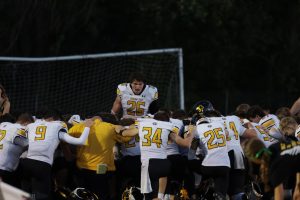 Huddled together in the south endzone of the Ralston football field,  running back, senior Connor Sams gives a motivational speech on Oct. 10. The Griffins went on to defeat the Rams 37-10.