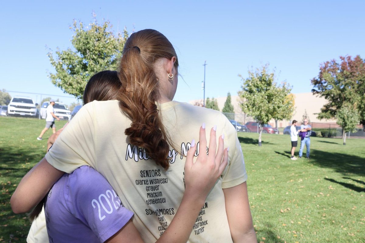 A season full of memories ends in a hug between senior Madisyn Clarke Wisnieski and sophomore Jenna Jackson.
