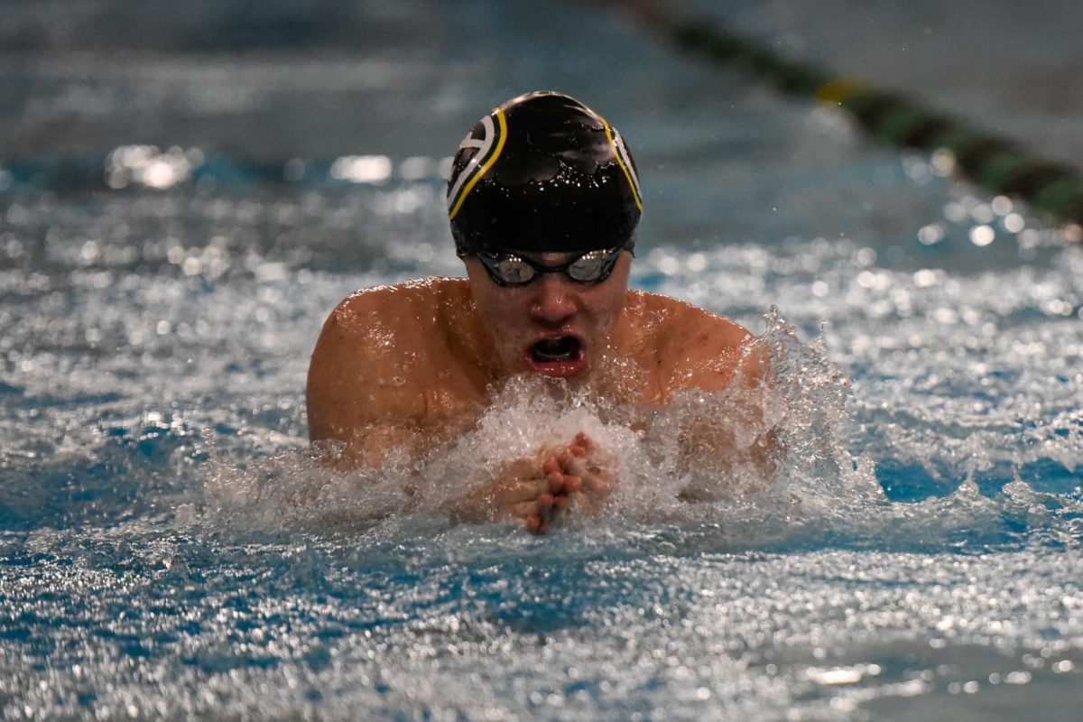 Slicing through the pool, freshman Enzo Palumbo (Gretna High) swims breaststroke down the lane. Palumbo soared ahead of the other swimmers, finishing over five seconds faster than the second-place swimmer.