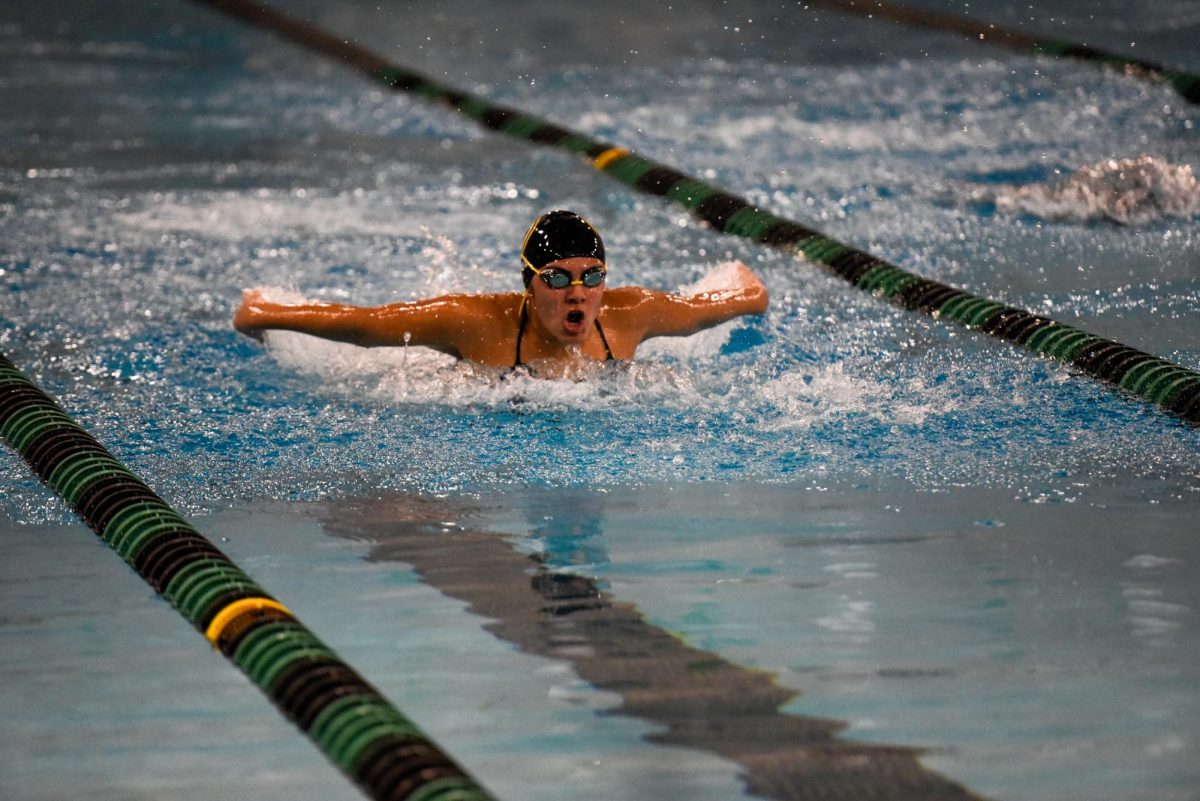 During a 100-meter butterfly race, sophomore Aliah Cruz sends herself toward the end of the pool. Cruz placed fifth, only a tenth of a second behind fourth place.
