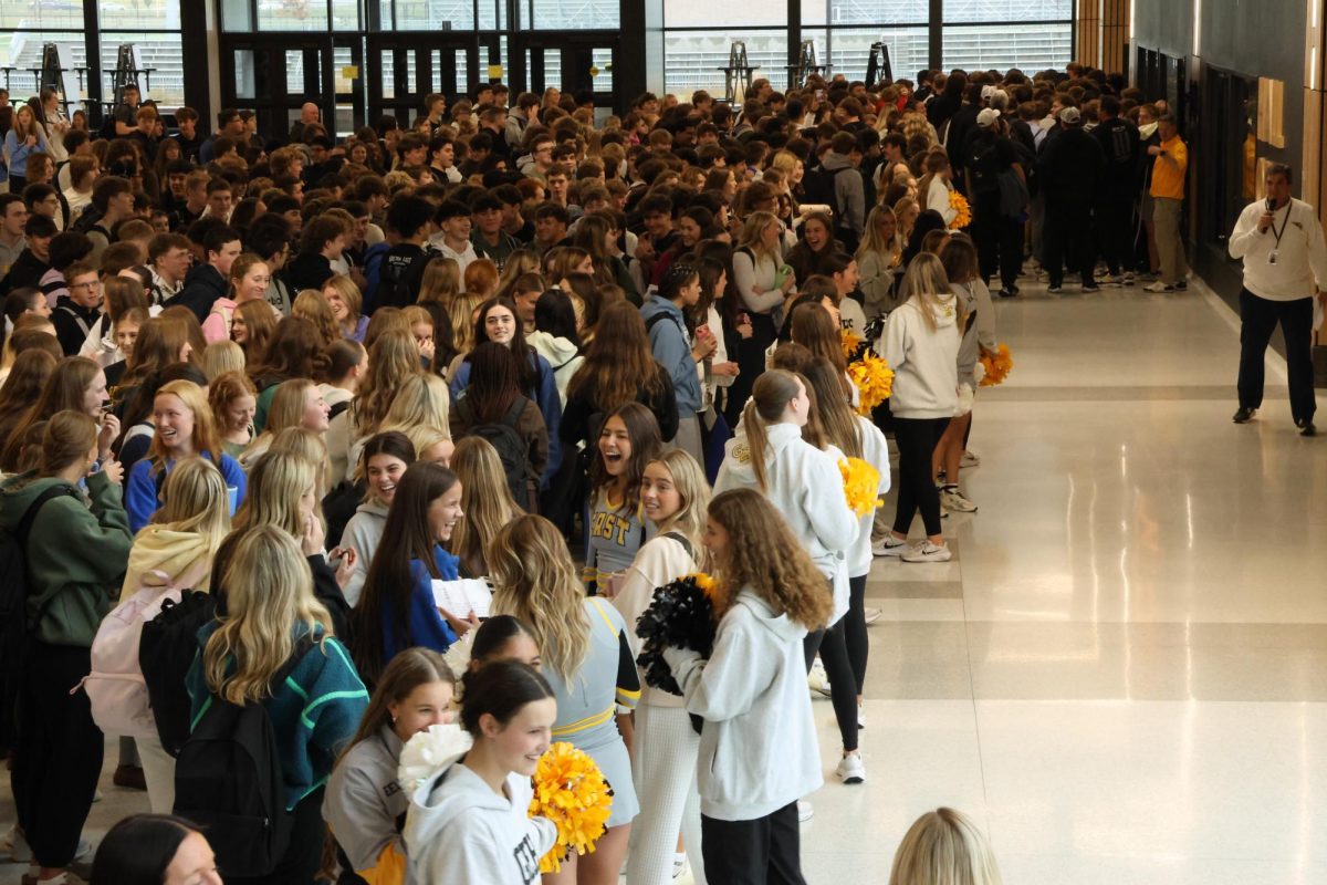 Packing into the commons, East students gather to cheer on the football team as they leave for the State Championship game. This marked the first-ever state send-off in East history. 