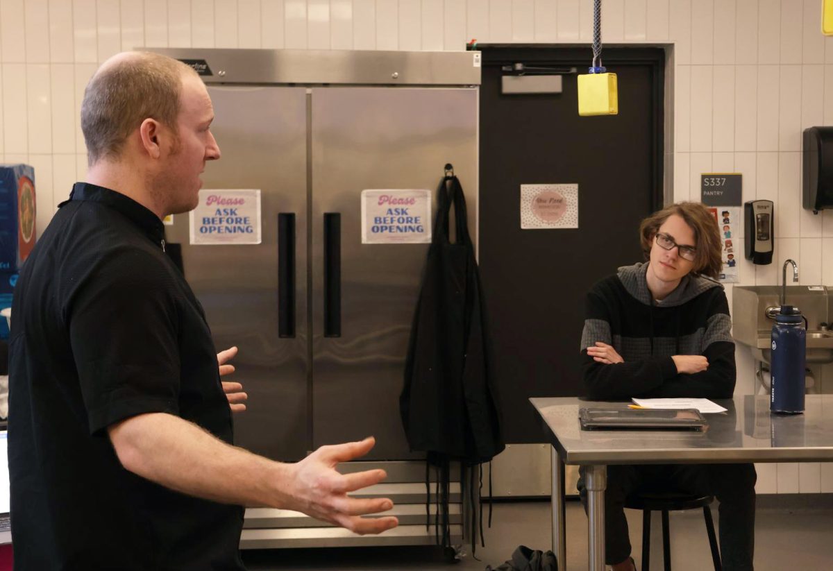 During his Prostart 2 class, senior Korbin Stastny listens to local chef, Shawn Lahood as he discusses culinary careers  with the class on Jan 27.