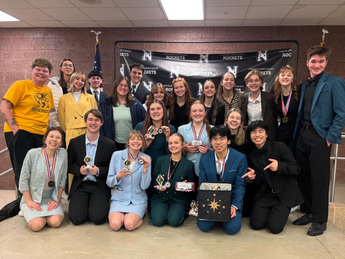 Commemorating their third place win at Lincoln Northeast's Space Race Speech Tournament on Jan. 30, the Griffin speech team poses for a group photo with their medals, trophies and coach, Grace Kimnach. "My team placed third at one of our toughest tournaments, right behind the two biggest schools in speech," Kimnach said. "I feel so proud to make art I believe in with the people I believe in."
