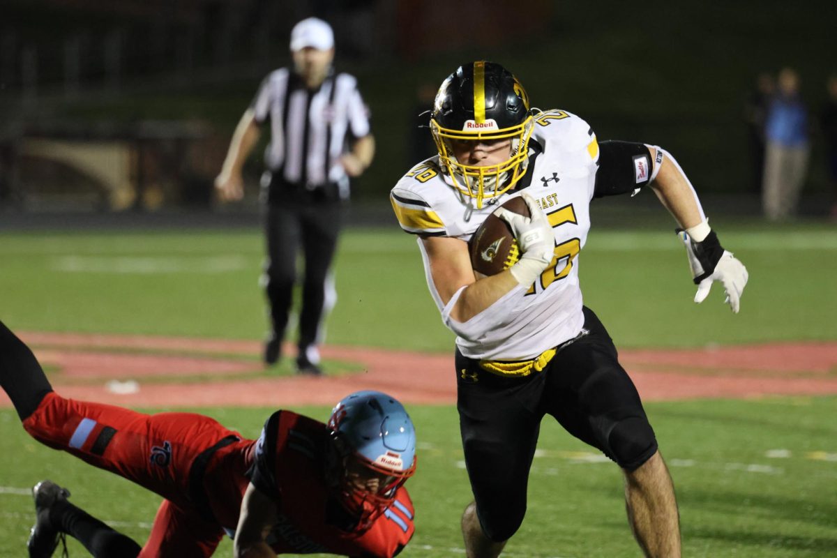 After getting the handoff in the second quarter, running back senior Connor Sams eludes a tackle attempt by a Ralston defender on Oct. 10. The play ended with Sams completing a 40-yard touchdown run, which contributed to the Griffins’ 37-10 win.