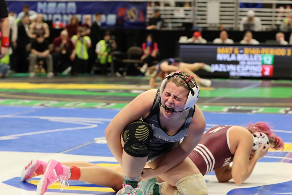 After winning her semifinal match, sophomore Ashlynd Fryer yells in triump after two hard fought periods against Norkfolk's junior Rylee Bauer. Freyer went on to compete in the championship against Westside's Addeline Graser.