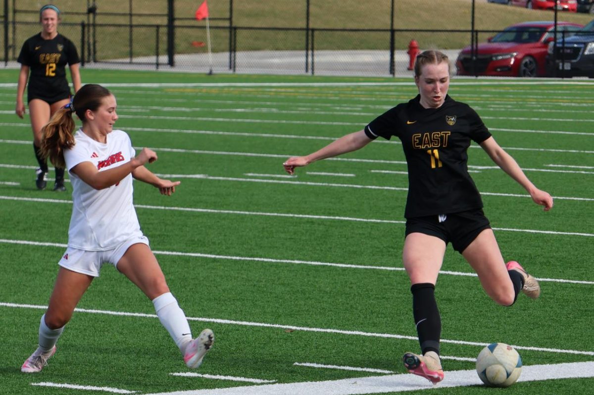 After receiving a pass from sophomore Maria Witt to clear the ball, junior Madie Shelburne dribbles back down field and sets up her kick to send it back down field on April 9, in the home game against Norris. The girls won the game 3-2 ahead of their April 13 game against Blair. 
