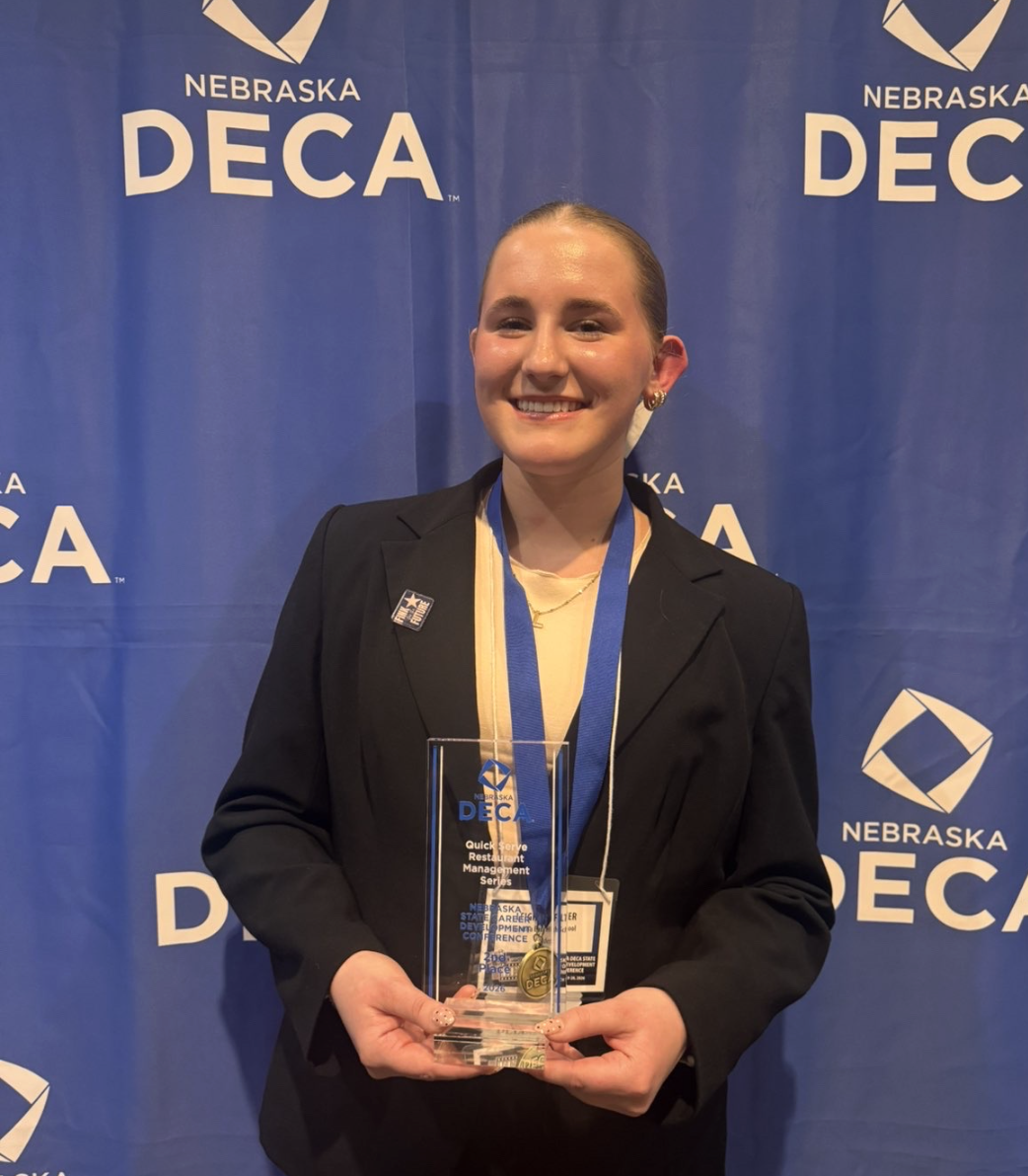 Holding her second place trophy, sophomore Leighton Filter smiles for a photo.