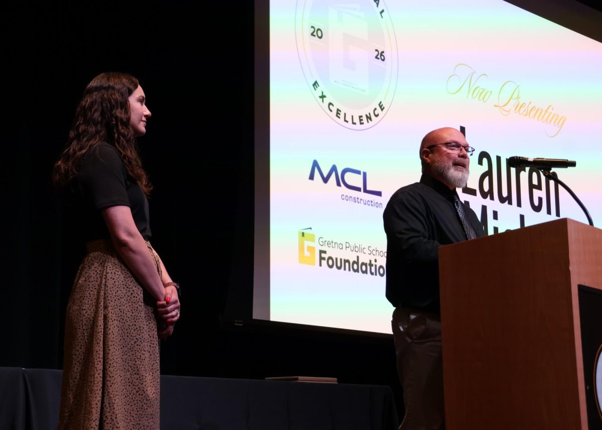 Congratulating her for 9-12 Educator of the Year, principal Chad Jepsen stands behind a podium speaking on math teacher Lauren Michal’s excellence and determination towards the betterment of the school and district on May 19. “When I was given the award, I was just very honored by what Mr. Jepsen was saying,” Michal said. “I have so much respect for that man and hearing him talk about me was really cool.” 