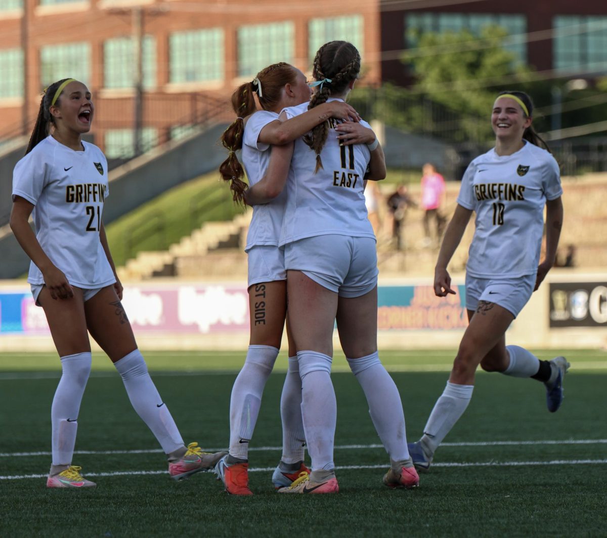Coming together, junior Lily Frederick, sophomore Taylor LaRock, junior Madi Shelburne and freshman Maria Witt celebrate as the team scores their first goal of the match. The goal was scored by Shelburne in the second half.