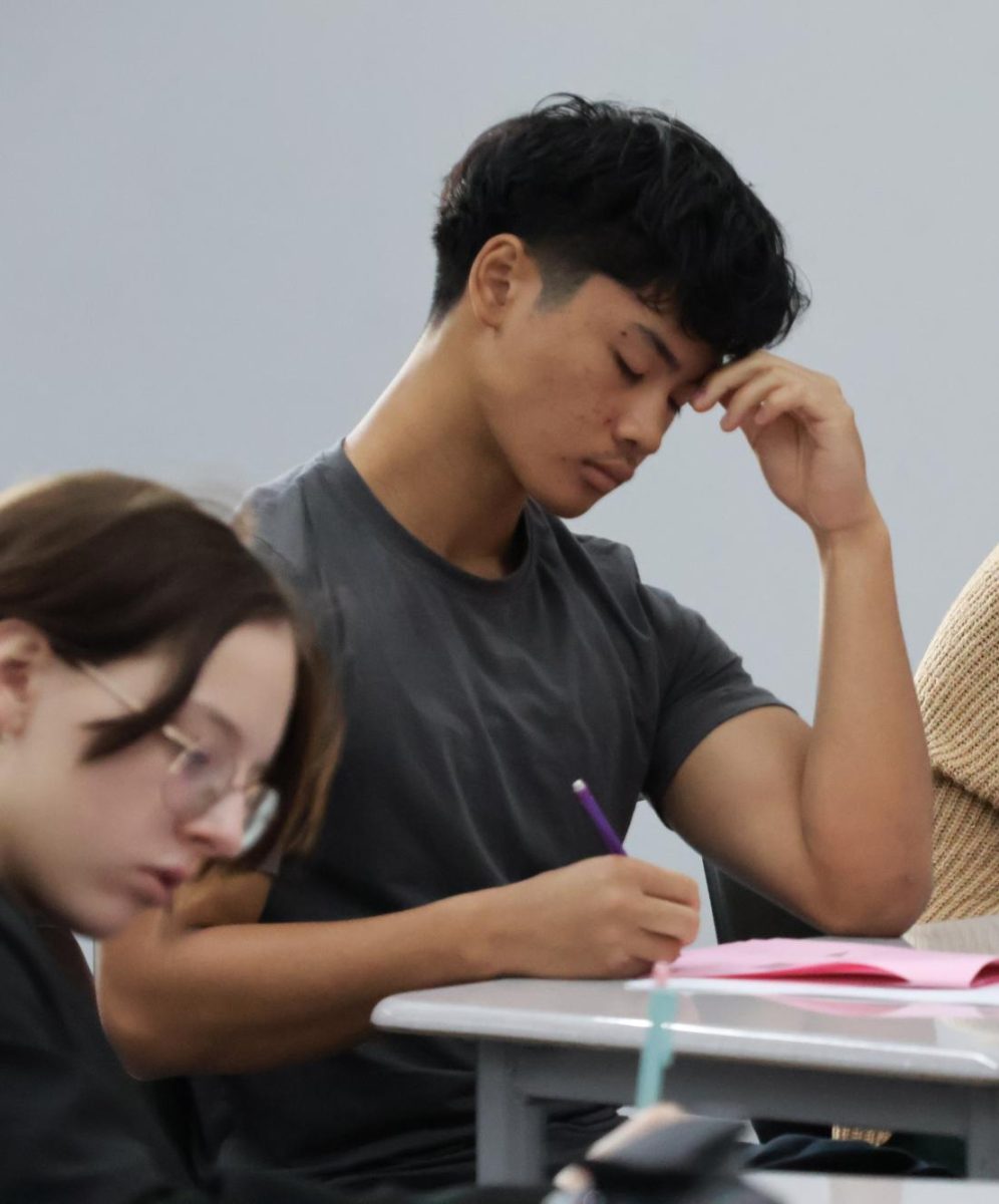 In his Algebra II class, freshman Tylan Bouasym holds his head as he works on his assignment.