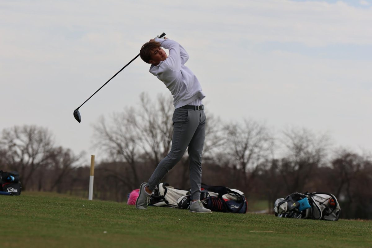 Driving down the green, junior Gavin Pedersen watches his ball soar through the sky at Tiburon Golf Club on March 26. Pedersen placed third at the district golf meet with a 76, helping his team claim the district title and advance to State.